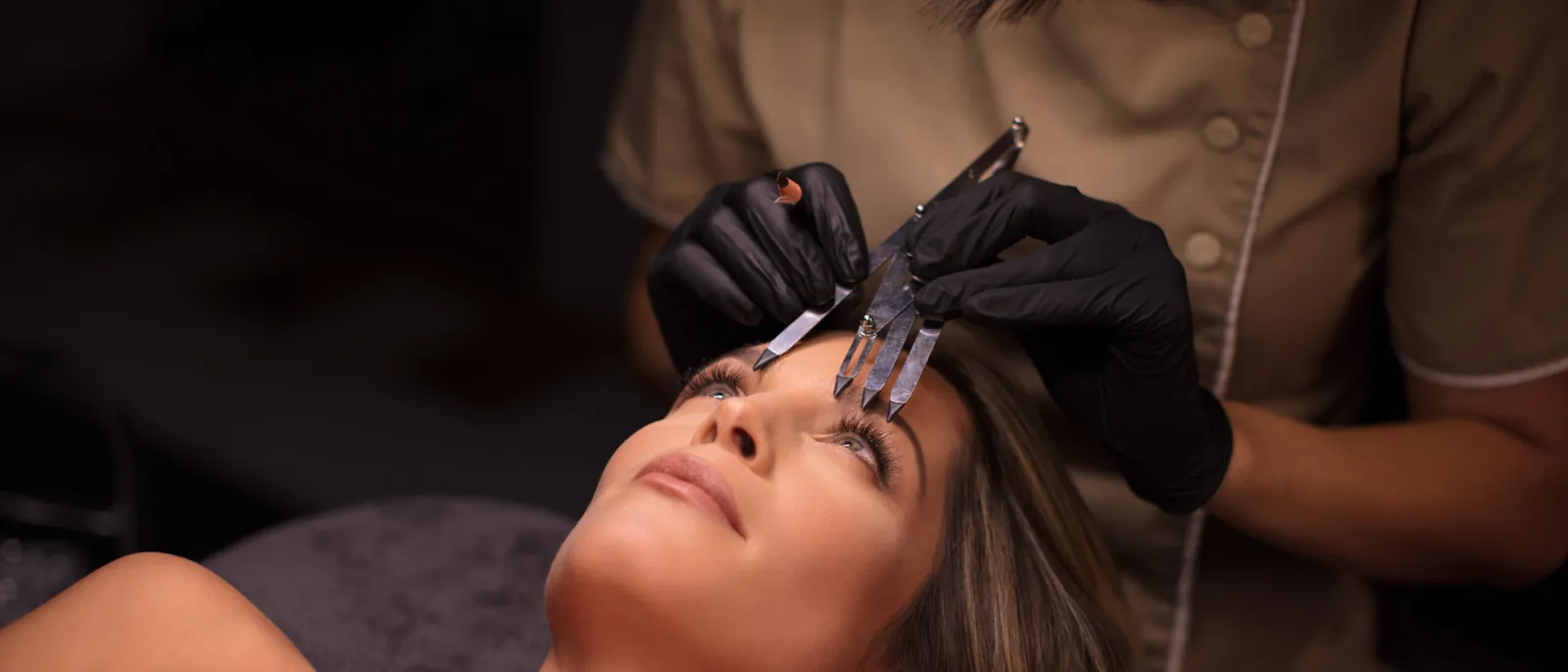 Microblading being applied to a shaped brow