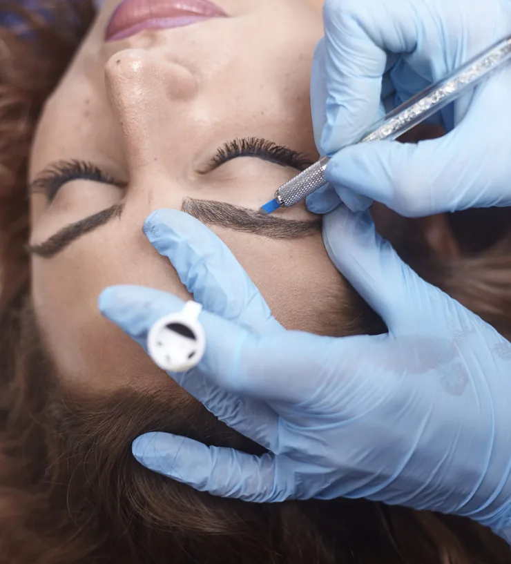 Microblading strokes being drawn onto a shaped brow